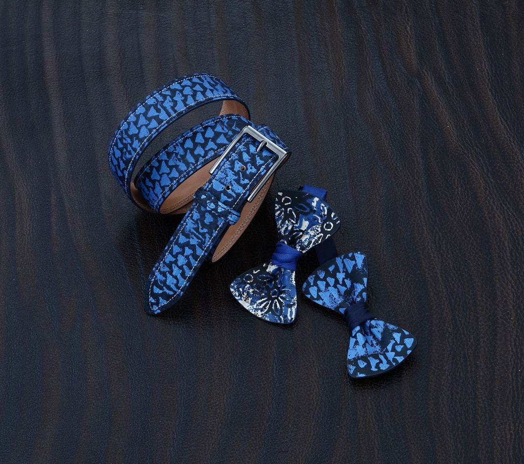 blue bow ties and belt in a brown leather background