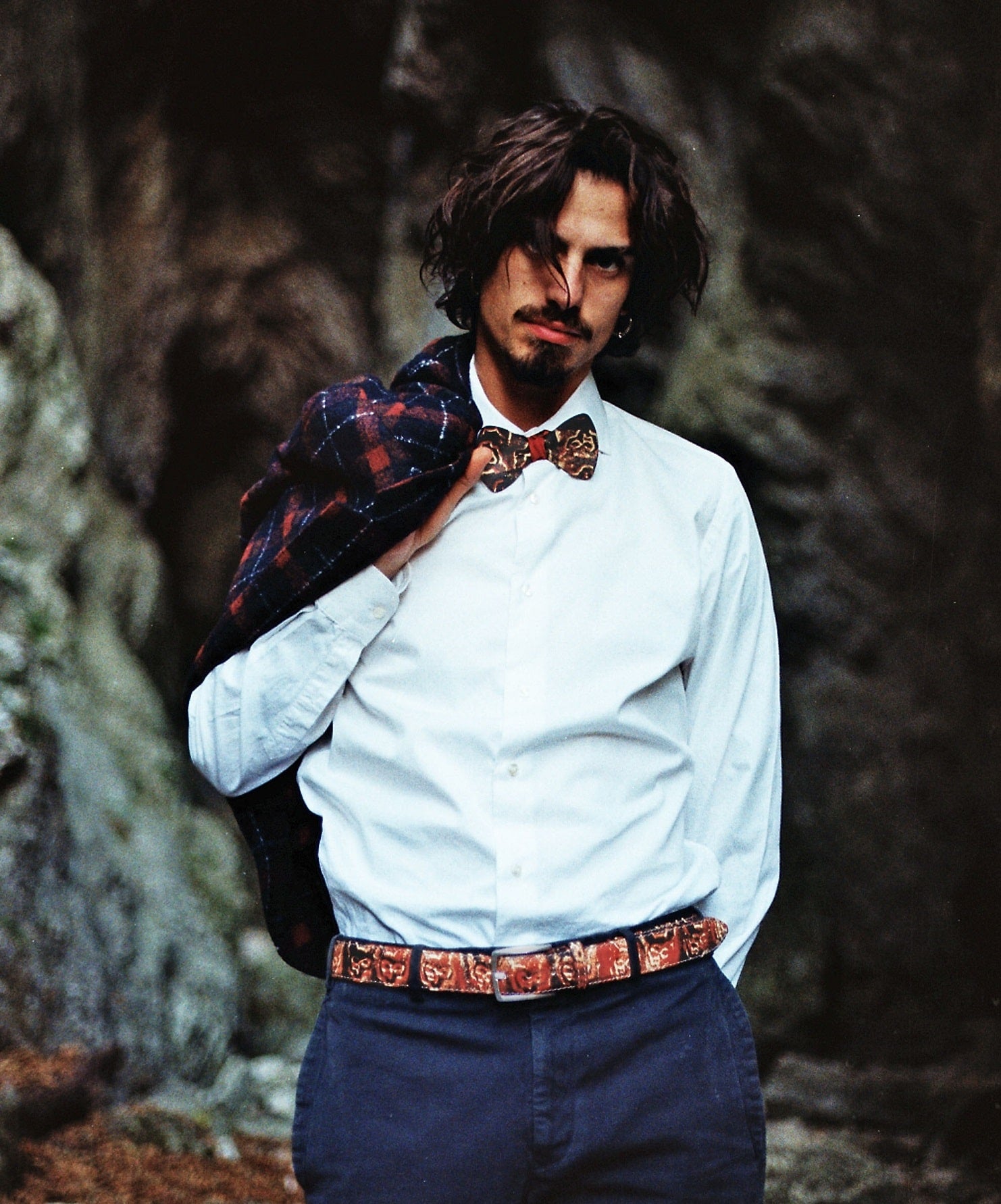 model in shirt wearing matching belt and bow tie