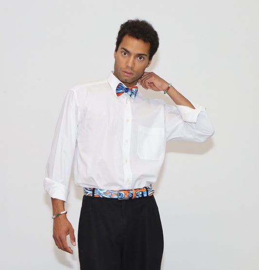 our model wearing black pants and a white shirt with painted bow tie and belt in a white background