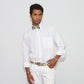 our model wearing white pants and a white shirt with painted bow tie and belt in a white background