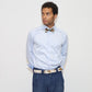 our model wearing blue jeans and a light shirt with painted bow tie and belt in a white background