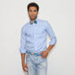 our model wearing light blue pants and a light blue shirt with painted bow tie and belt in a white background
