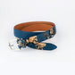 hand painted belt with white skulls on a blue background